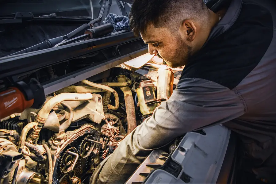 A Tannadice Motors mechanic working under the bonnet
